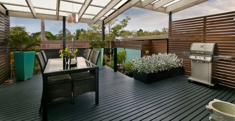 Deck lattice alternative featuring wooden slats going sideways holding a grill and patio table