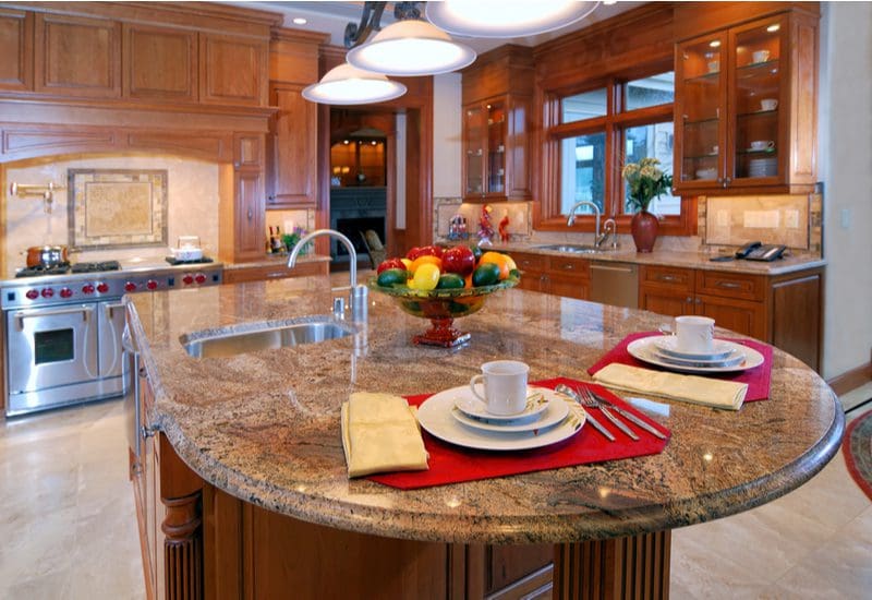 Close up of an Island Breakfast Nook idea with a rounded granite breakfast bar