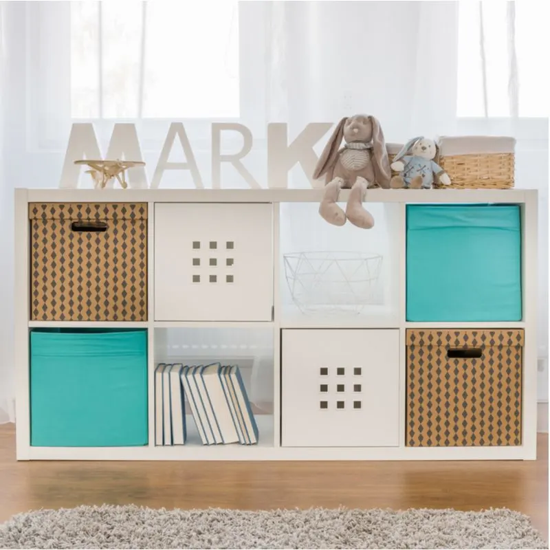 An idea for living room toy storage featuring storage cubes in white with brown patterns and teal cubes mixed together