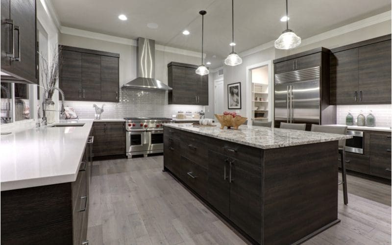 Gray colored wood floors with dark cabinets