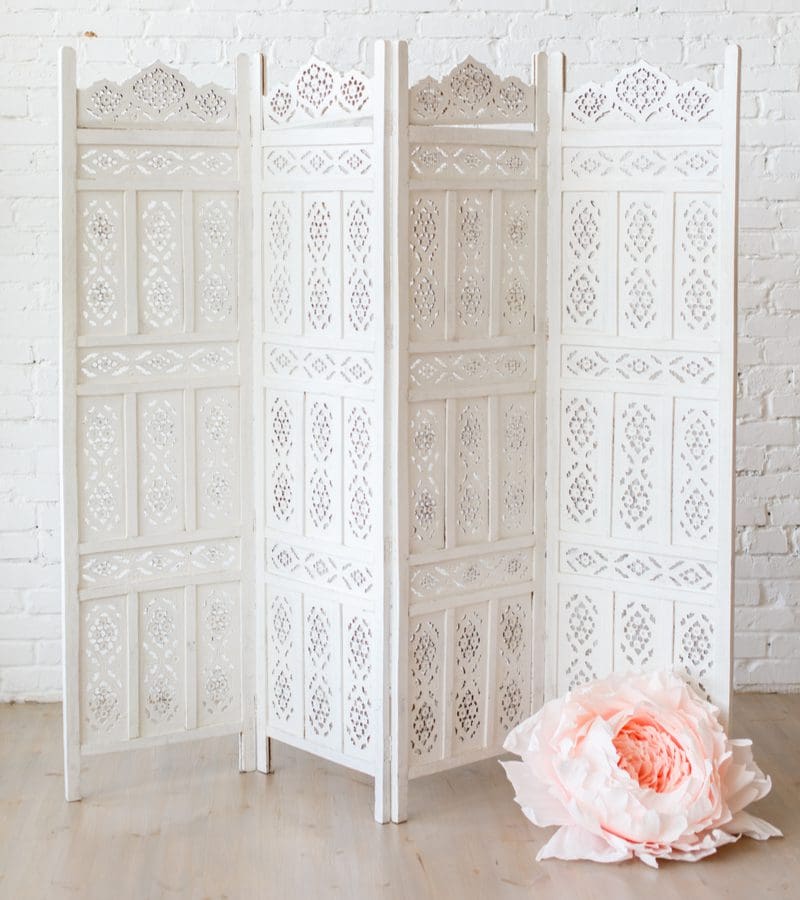 Living room toy storage idea featuring a room divider in white