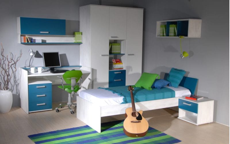 Swanky blue and green teen boy room decorating idea with white furniture and teal blue drawers and rug