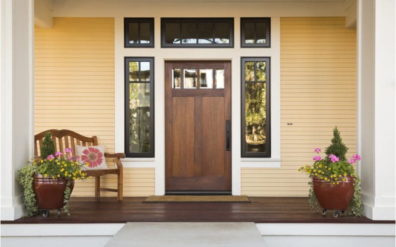 Natural Wood front door color for a yellow house