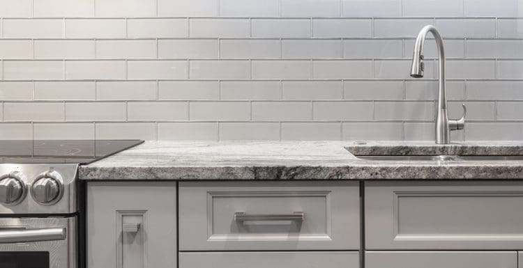 Featured image showing a kitchen with subway tile backsplash in white color with white grout