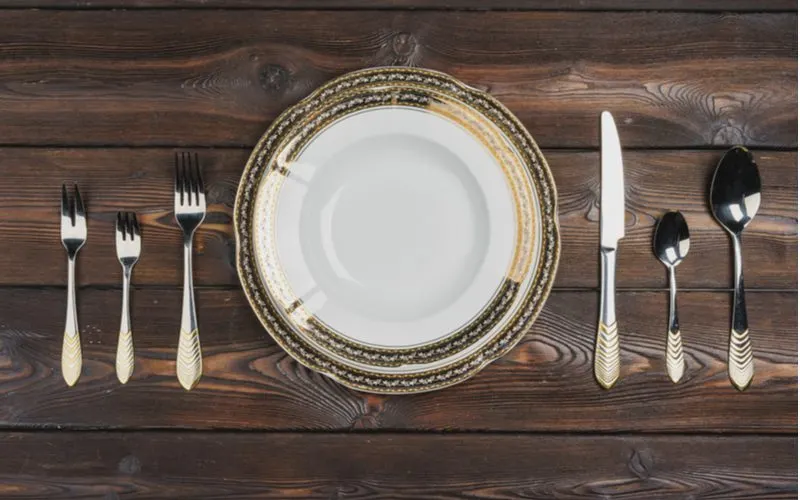 Place setting with various types of forks on the left side of the plate