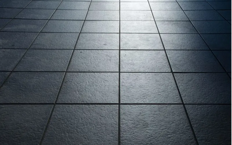 Dark black kitchen flooring ideas with black subway tile
