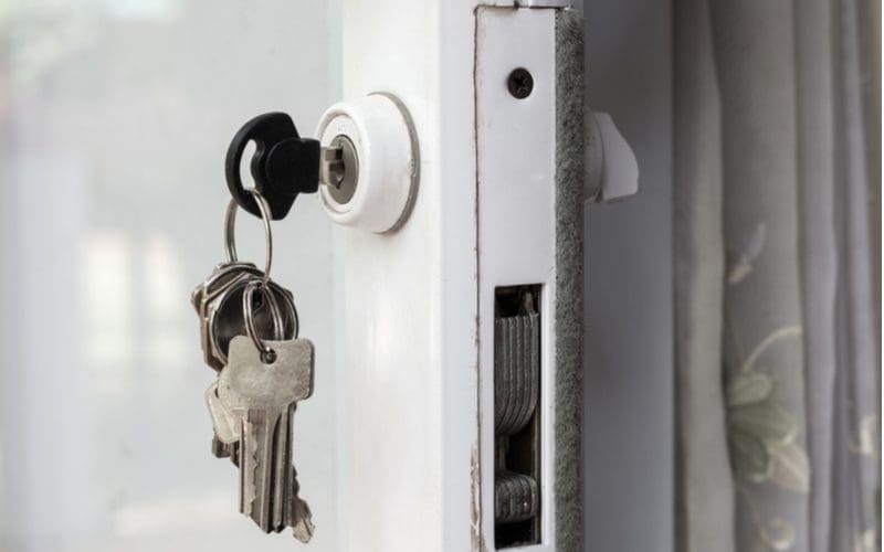 Keys hanging from a deadbolt, one of the most popular types of sliding door locks