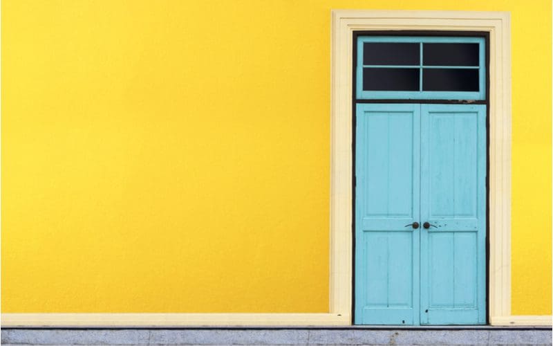 Teal blue, a favorite front door color for yellow houses