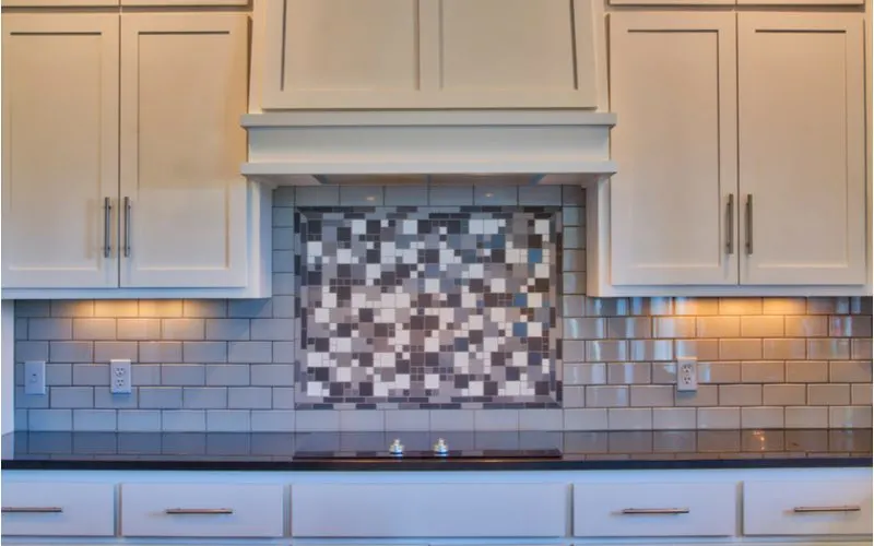 Light Gray Subway Tile Backsplash With Pixel Mosaic Centerpiece