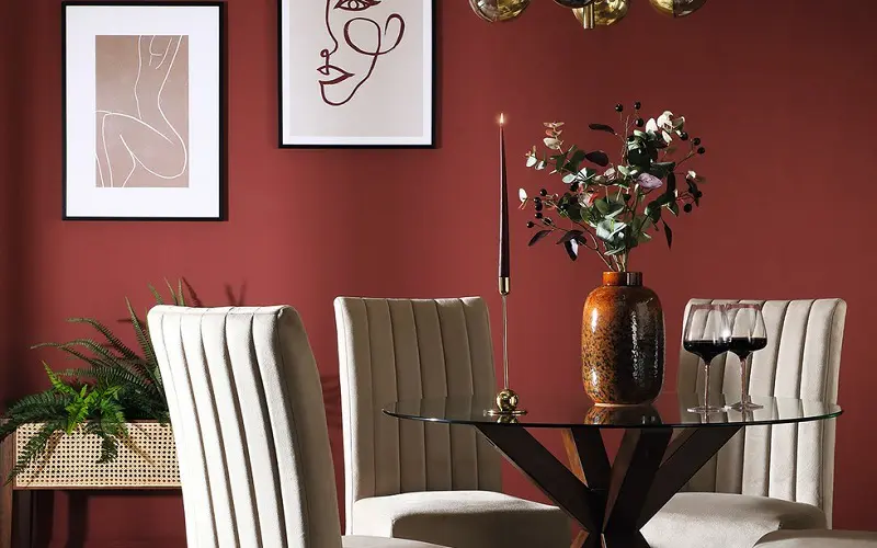 Beige chairs and maroon colured wall