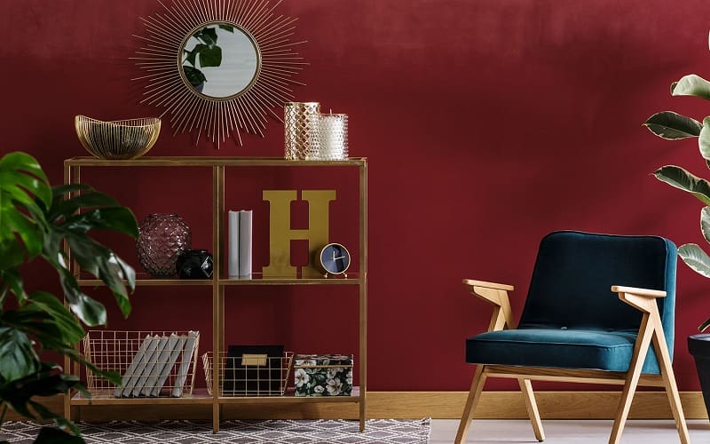 Living room with maroon wall and blue chair