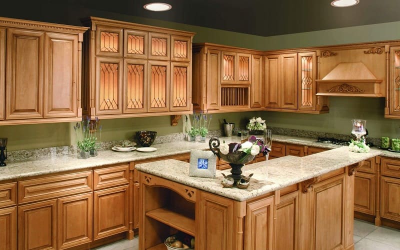 Kitchen with light green walls and light maple cabinets