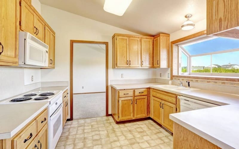Light maple cabinets and white countertops are a great choice if you want simplicity, function, and a great look.