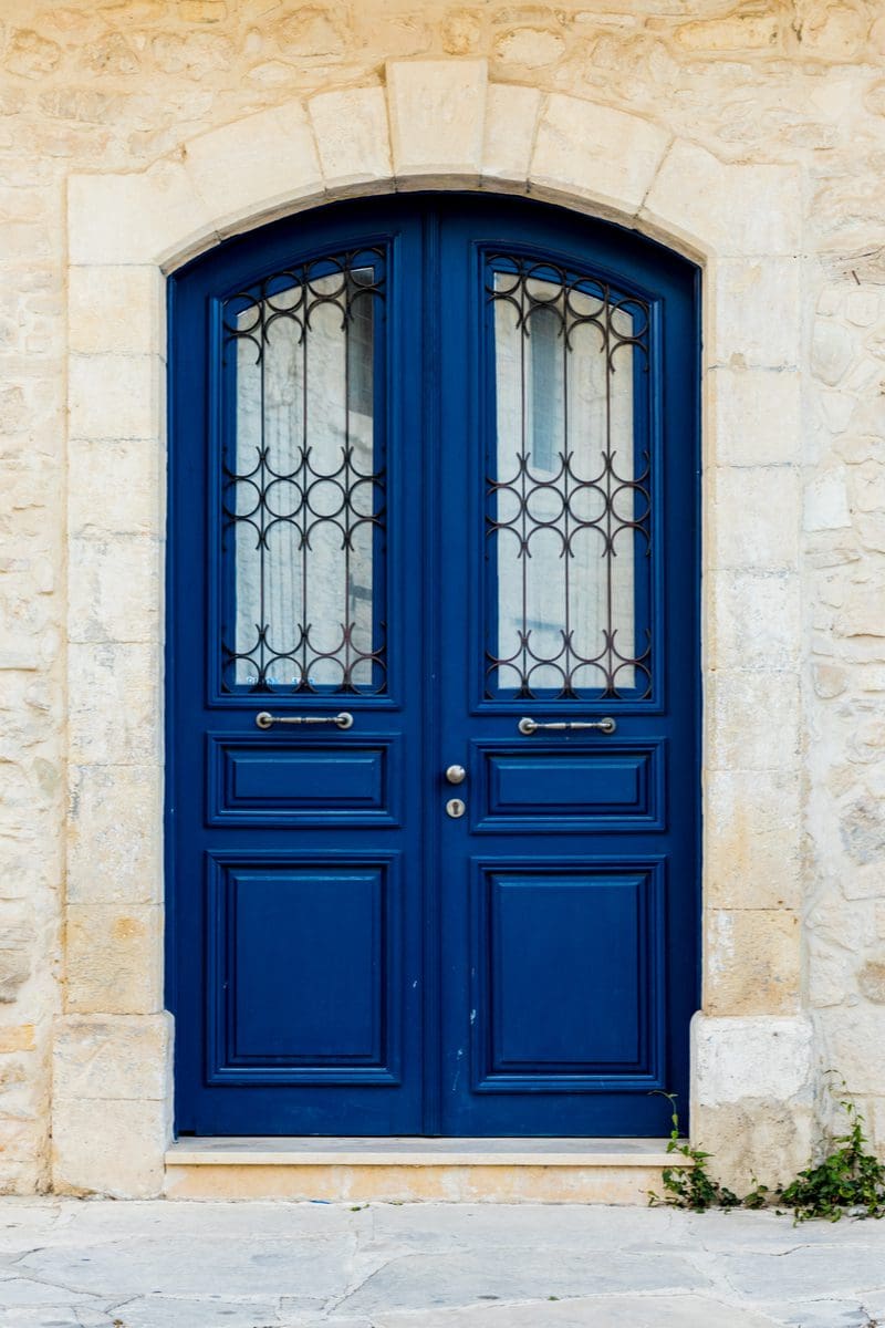 Dark blue colored front door on a white house