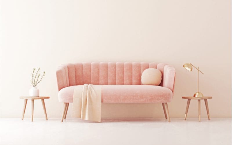 Blush pink sofa with gold accents as a color that goes with gold