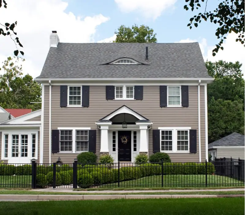 Stately Warm Grey House With Black Shutters