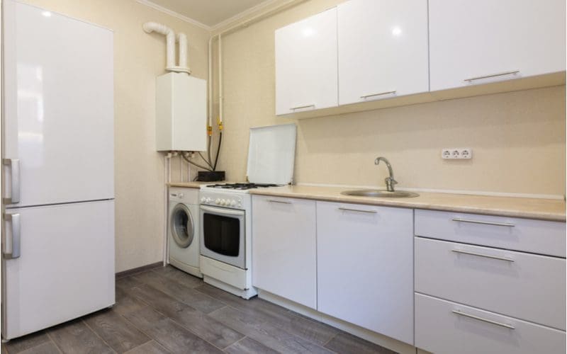 Apartment size stove next to a small washing machine