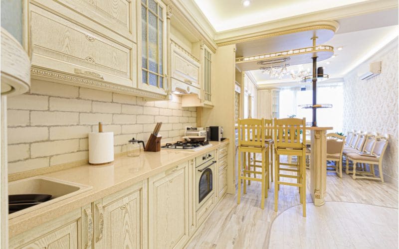 Proper Provencal Kitchen with off-white granite countertops