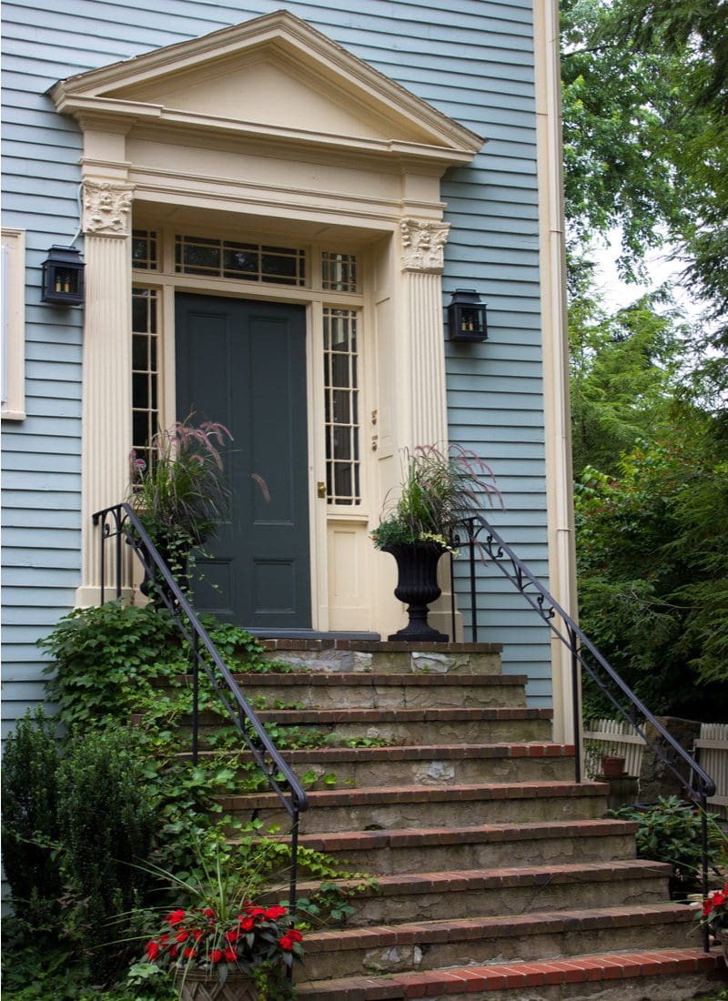 Dark grey front door color for a blue house