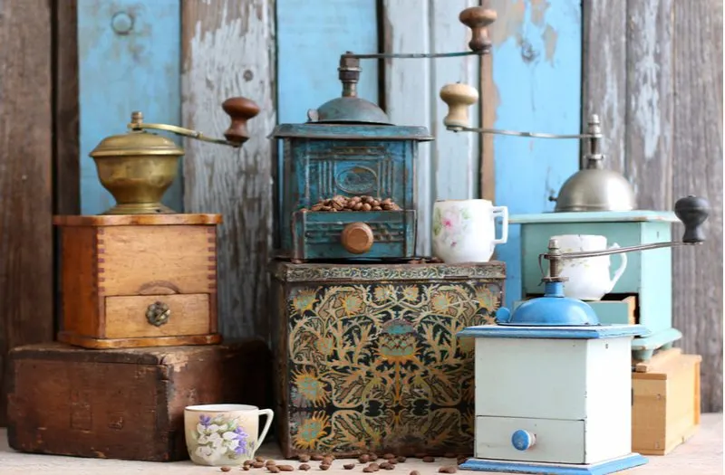 Vintage Coffee Grinders sit in a blue and brown kitchen