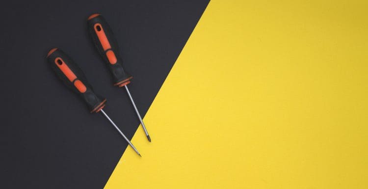 Few different types of screwdrivers on a yellow and black background