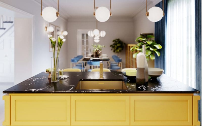 Yellow cabinets with black granite countertops