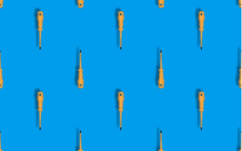 Bunch of types of screwdrivers on a blue background