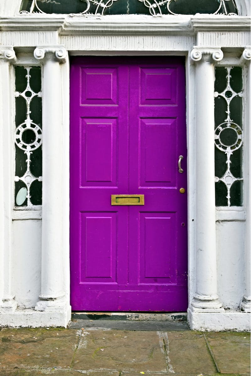 Bright purple, a very bold choice when choosing front door colors for white houses