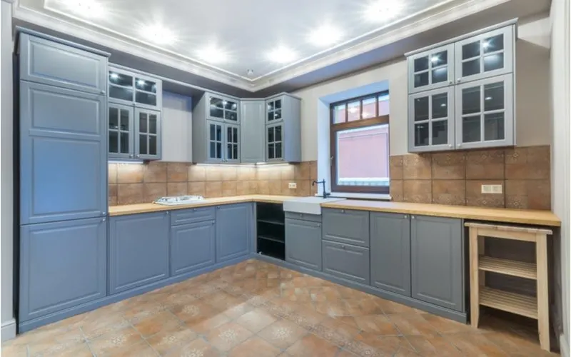 Combine Light Blue Cabinets & Tan Tile Walls and Floors in a Blue and Brown Kitchen