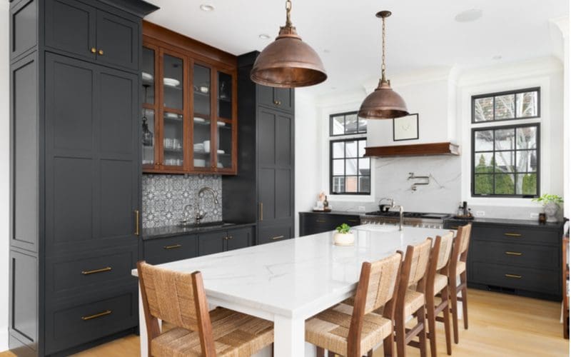 Black countertop idea with rustic elements and a white table