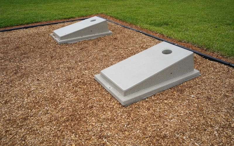 Cornhole bags boards with very small holed with a mulch court