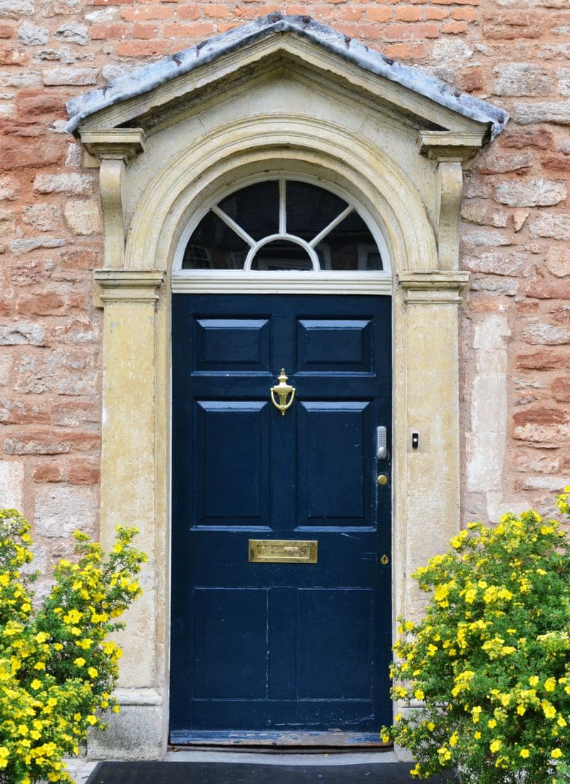 Navy Blue Colored Front Door on a Brown House