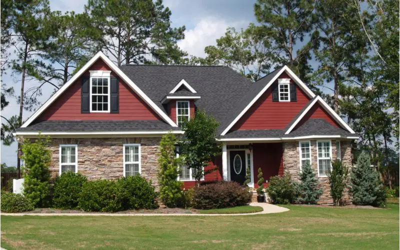 Red and Beige Combo With Black and White Details, one of our favorite Black Roof House Color Schemes
