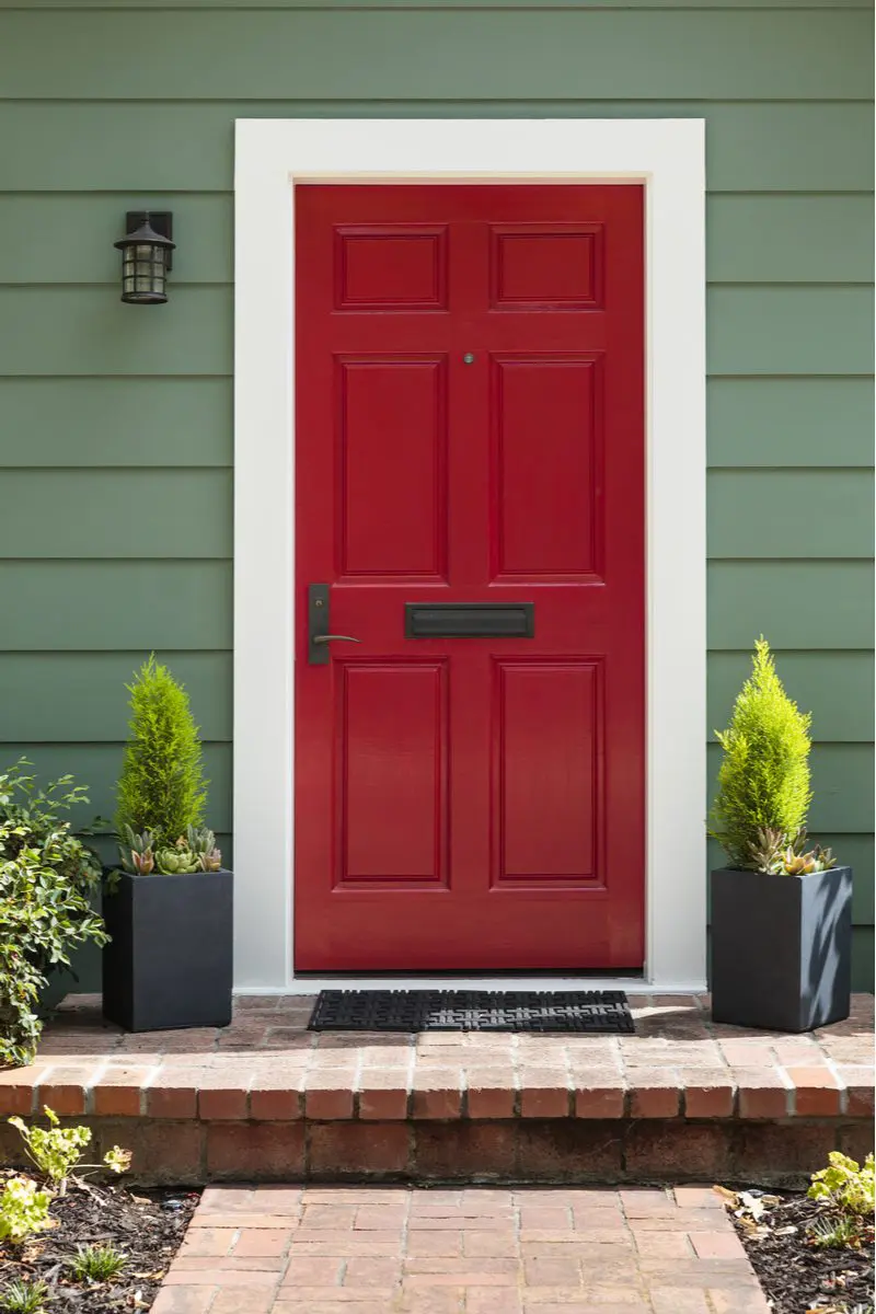 Maroon front door color for green house