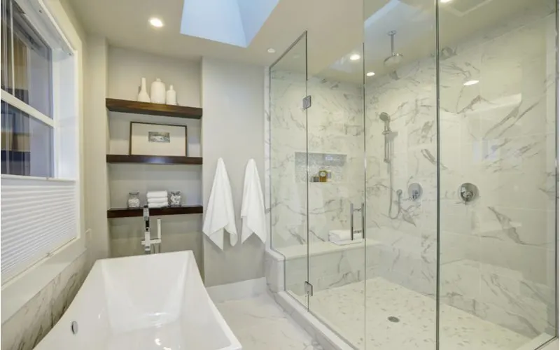 Master bathroom layout idea with floating shelves above the tub
