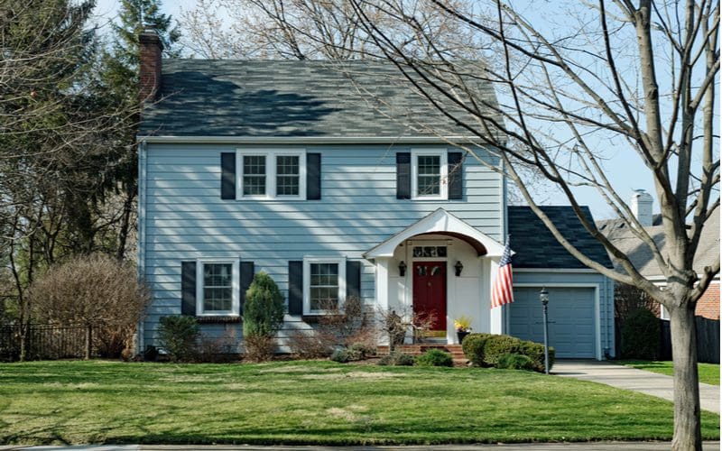 Colonial Style House in Blue With White Trim and Red Door With a Black Roof House Color Scheme