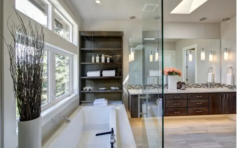 Master bathroom layout idea with a tub and a glass half-wall