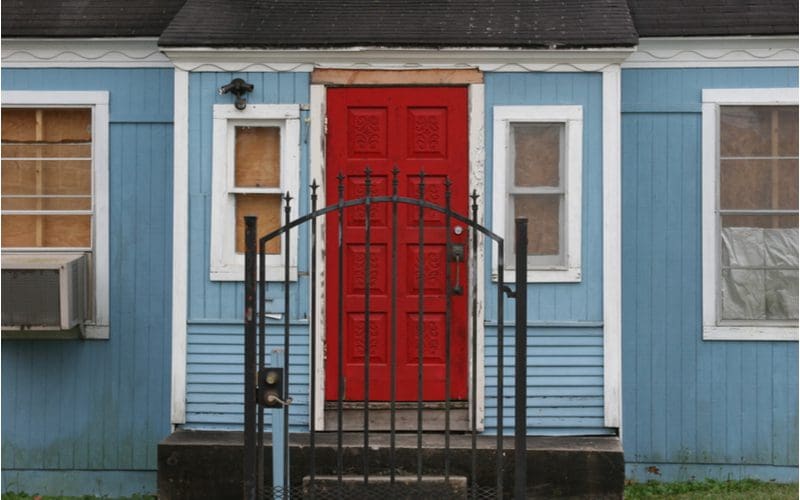 Brick red front door color on a blue house