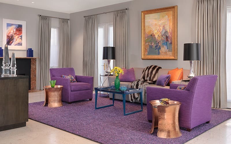 Living room with lavender sofa and chair and copper details