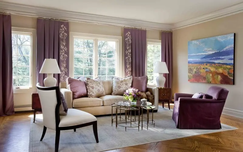 Neautral beige living room with lavander details and curtains