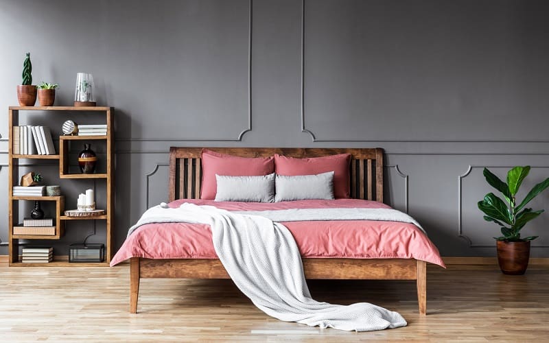 Pink bedsheets and black walls