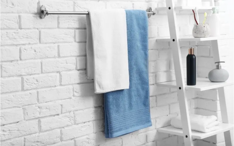 Image of the standard towel sizes hanging from a towel rack