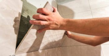 Guy showing us how to tile inside corners in a shower