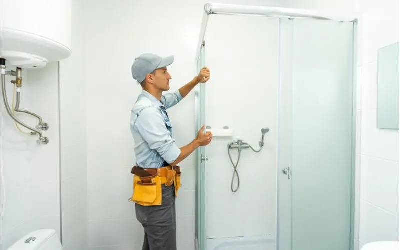 Man installing a standard code height shower door