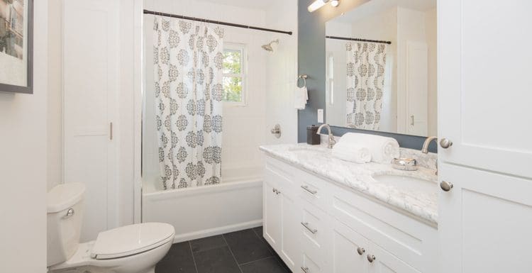 Shower curtain covering tile in a bathroom