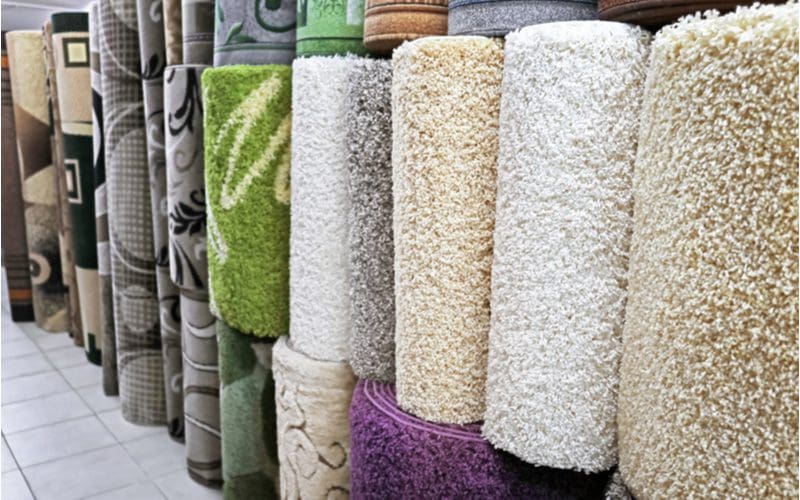 Image of a bunch of rugs in a store for a piece on what color rugs go with grey floors