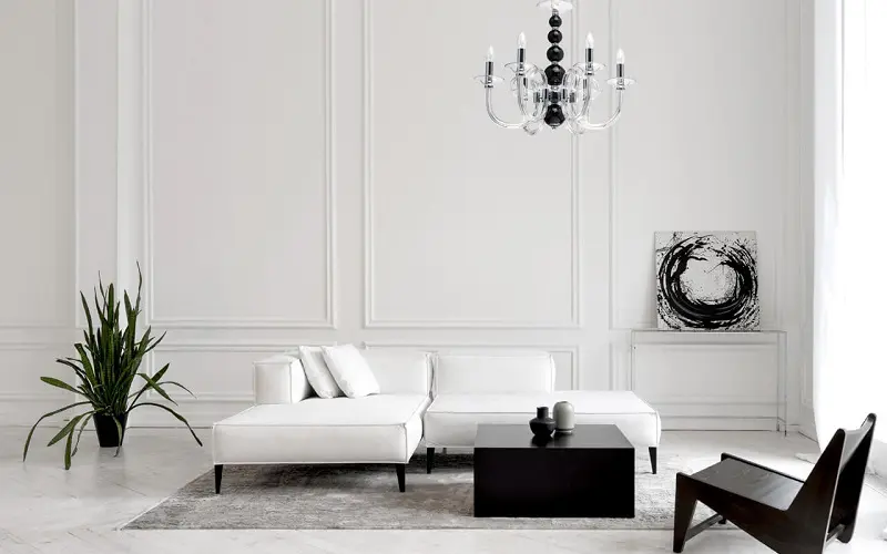 Kiving room with white wood panel walls white sofa