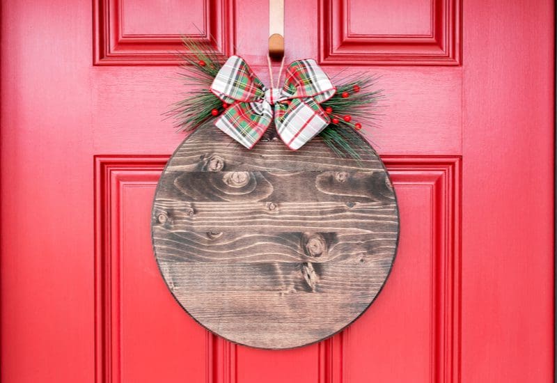 Front door decor idea featuring a sign with a bow