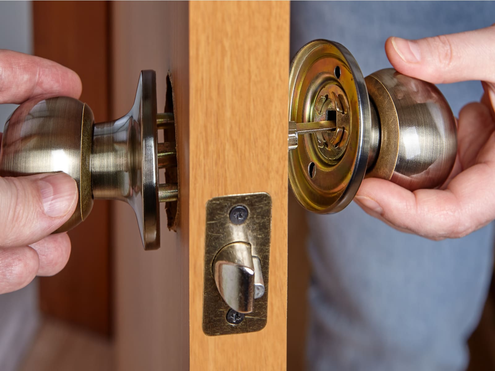 Two sides of a doorknob for a piece on how to unlock bathroom doorknob lock with a hole