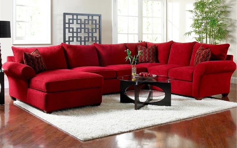 Red Leather Sectional and White walls living room